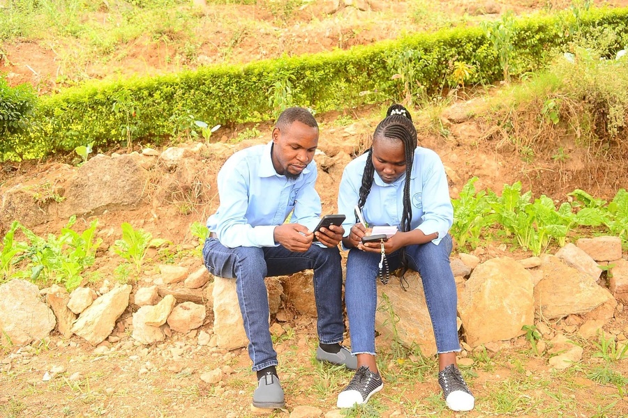 Colleagues sharing notes outdoors
