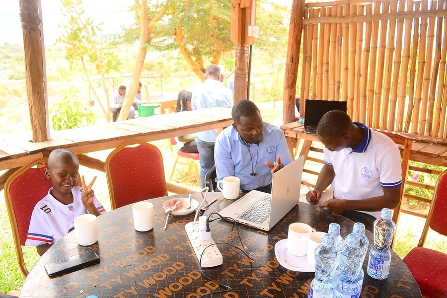 Maesio colleagues and family at an outdoor table